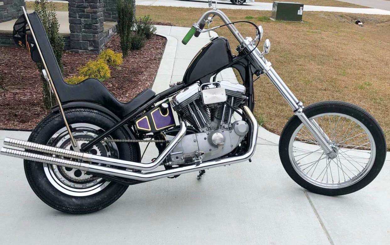 black sportster chopper in driveway with purple paint on tank