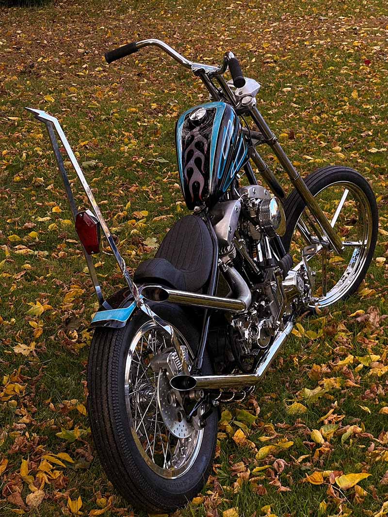 shovelhead chopper with blue paint and purple flames